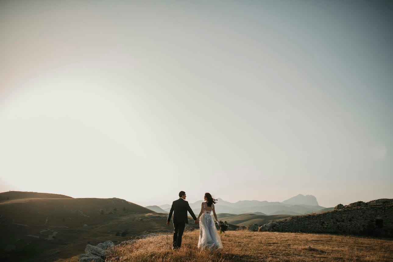 The couple walking together across the hills